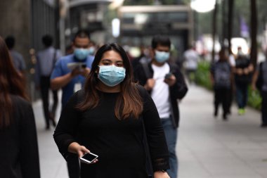 Manila, Philippines - February, 3, 2020: Filipino woman in the street wear mask against virus