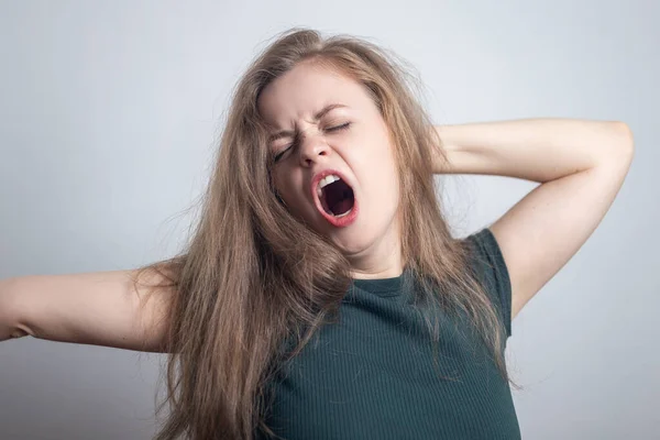 Young caucasian woman girl, yawning, tired or sleepy with messy hair