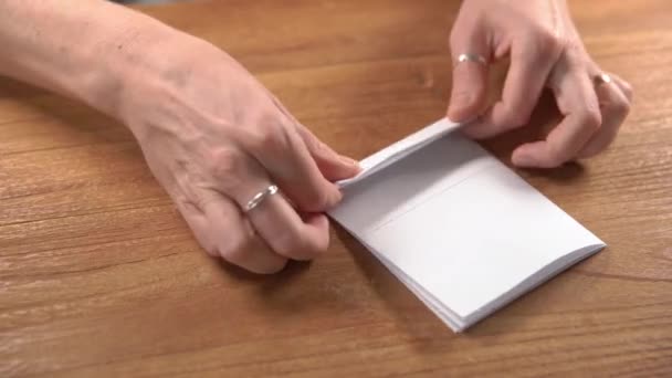 Papel doblado en cuadrados como base para el origami — Vídeos de Stock