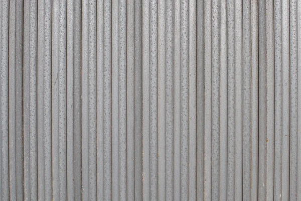 Metal sheets next to each other form the foundation for a metal gate or fence. Structure for background or wallpaper — 스톡 사진