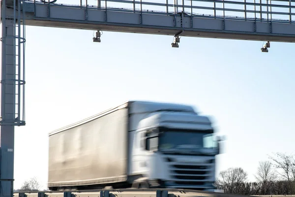 truck drive through the highway through the toll gate, toll charges, blurred motion in the image