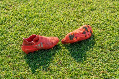 Chiklana de la frontera, Spain - January 9, 2020: red football boots adidas on the grass