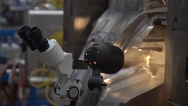 The engineer checks the correct setting of the metal mold for castings in the factory using a microscope — Stock Video