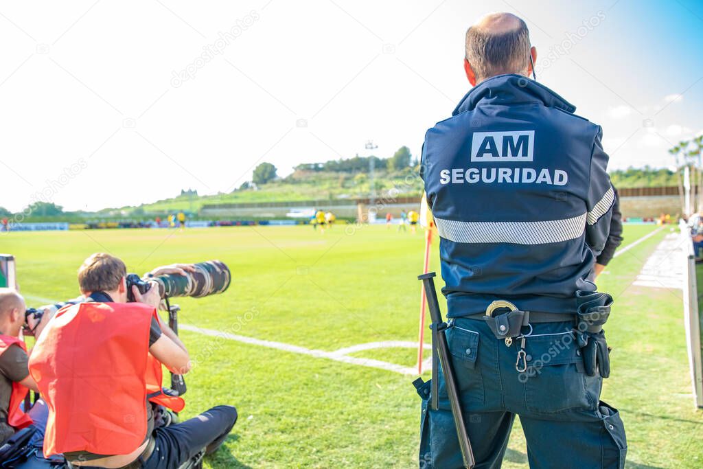 security guard on a football match. title on his back in Spanish BODYGUARDS