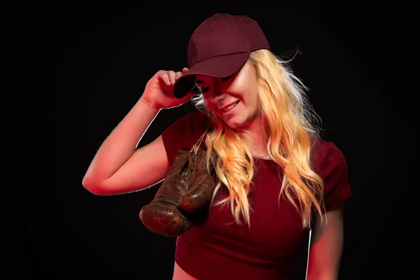 Portrait of woman with old boxing gloves on black background, copy space — Stock Photo, Image