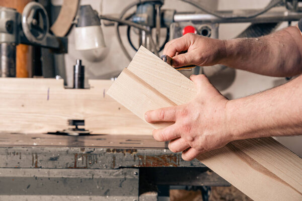measuring wood before processing in joinery