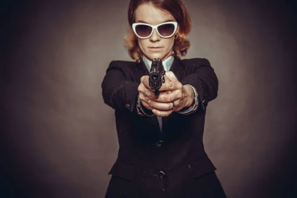 Aiming weapon woman in suit. dangerous situation, endangerment — Stock Photo, Image