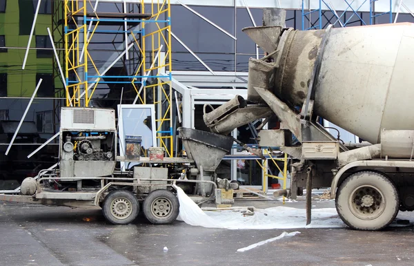 concrete pump and concrete mixer to work together to pouring cement floors in the shopping center for repair