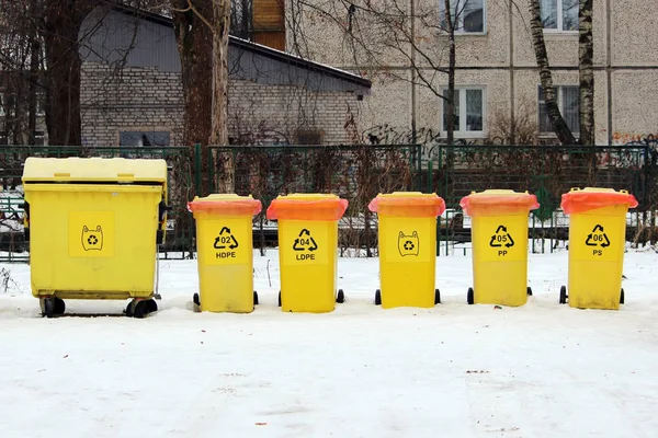 Several yellow Bins For Collection Of Recycle Materials.