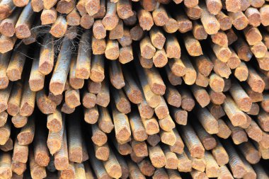 Paslı demir çubuklar viyadük inşaat alanının yakınındaki bir yığının içinde duruyor..