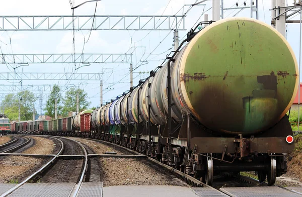 A lot of colored cars on a freight train, which travels along the rails of the railway. Stock Image