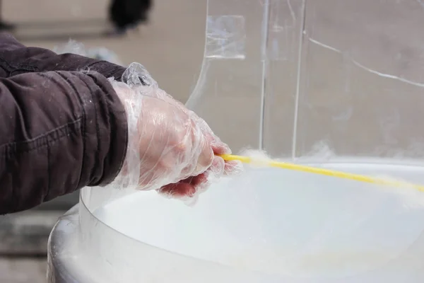 making white cotton candy in cotton candy machine.
