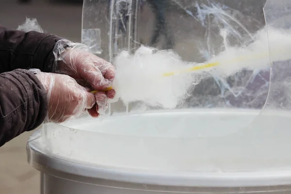 making white cotton candy in cotton candy machine.
