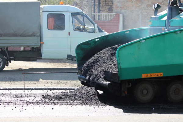 Car for asphalt road with crumb of asphalt in a scoop