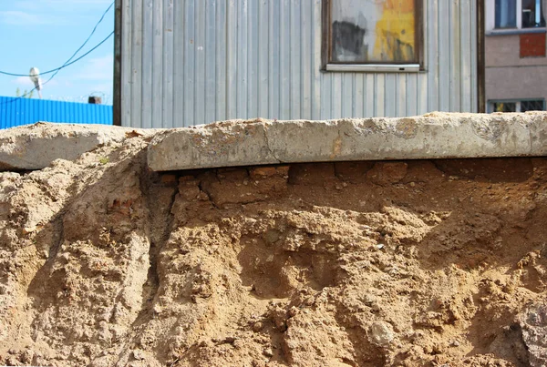 Betongplattan ligger på en plattform under ett lager av sand. Olika nivåer av. — Stockfoto
