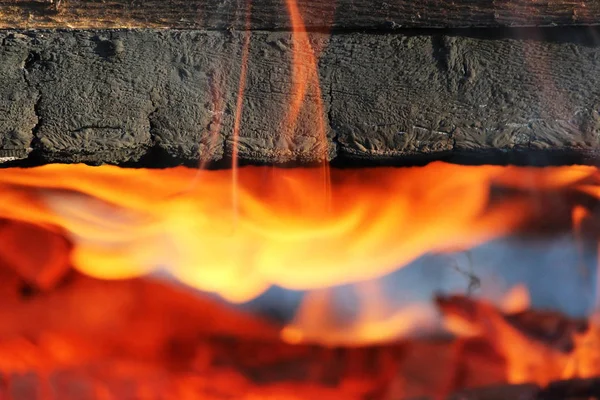 Ognisko, w którym stare deski malowane są otoczone w ogień — Zdjęcie stockowe