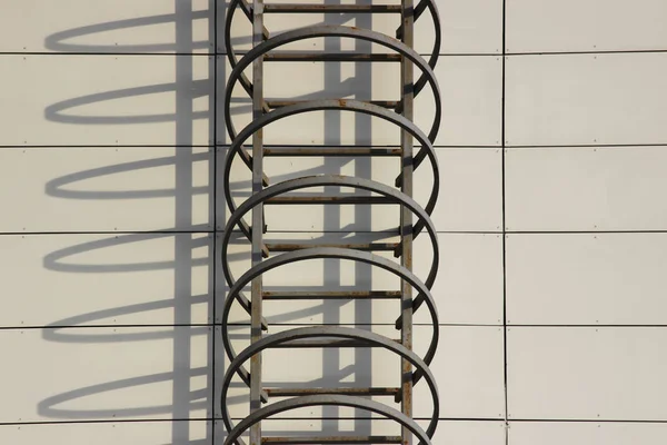 Fire escape and shadow on the wall of an office building