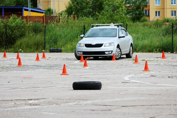 many plastic signaling traffic cones and Rubber tires from wheels are on site for training where drivers learn to ride on cars