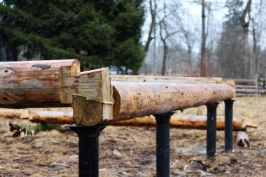 Bir ahşap çerçeve montaj ve bir ev inşa. Rusya. Eski ahşap günlükleri ve metal sütunlu Bankası doku