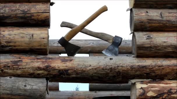 House from a bar under construction and two axes. — Stock Video