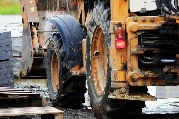 El tractor se encuentra en el sitio para reparar la zona con baldosas de pavimentación . — Foto de Stock