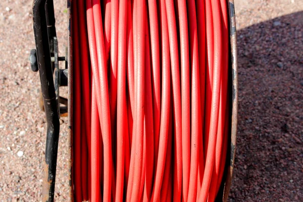 A continuous coil of red thick cable on the coil. — Stock Photo, Image