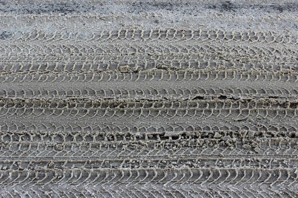 Many detail footprints wheel tracks in the mud snow.