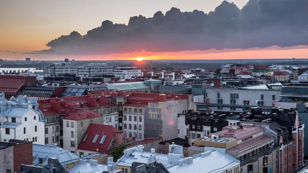 Helsinki rooftops at Sunset with dark clouds — Stock Photo, Image