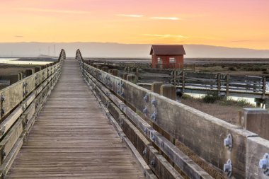 Wooden Bridge and Cabin Landscape. Sunset at Don Edwards San Francisco Bay National Wildlife Refuge, Fremont, Alameda County, California, USA. clipart