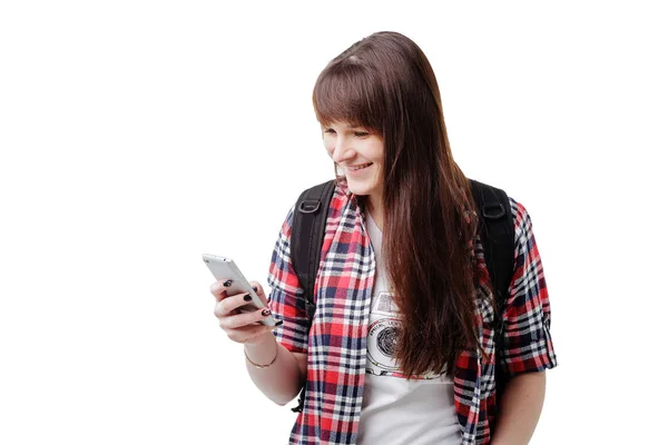 Hipster young woman waiting for someone and using smartphone on white background. Travel vacation getaway trip concept. — Stock Photo, Image