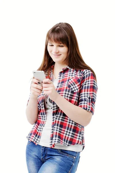 Attractive brunette in jeans and a plaid shirt In Use your mobile phone — Stock Photo, Image