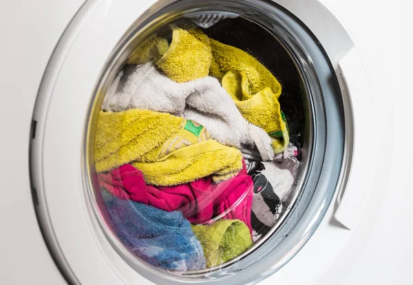 Washing machine door, clean colorful clothes, yellow, blue plush terry