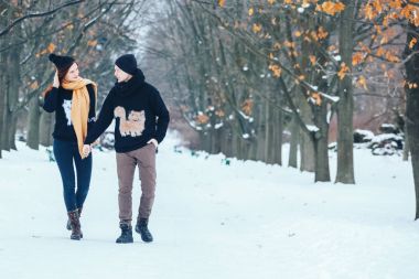 Çift birlikte karlı ormanda yürüyüş gülümseyen