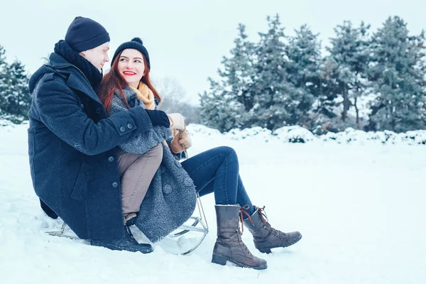 bir kış tatil zevk ve karlı kış gününde eğleniyor aşık genç Çift.