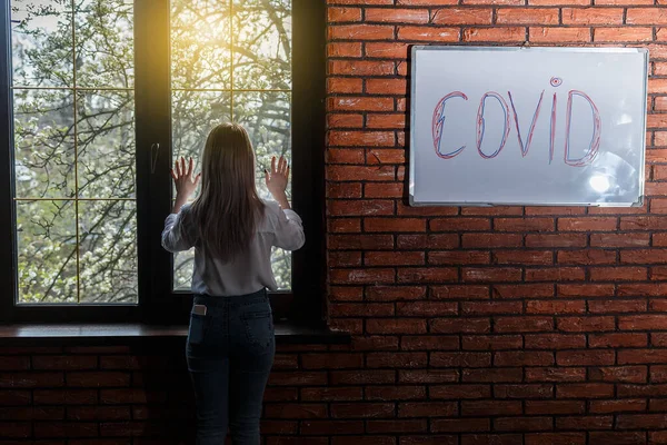 Inscription Wall Word Covid Young Woman Standing Window Room Brick — Stock Photo, Image