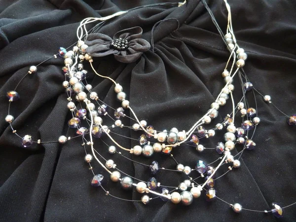 Decorative bijoux accesories on a black fabric — Stock Photo, Image