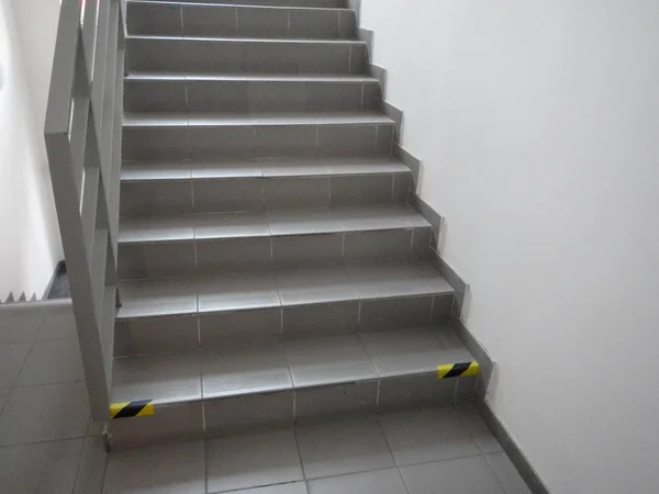 simple grey tiled indoor staircase