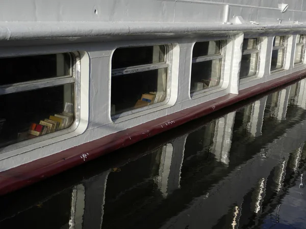 boat windows reflected in a water level