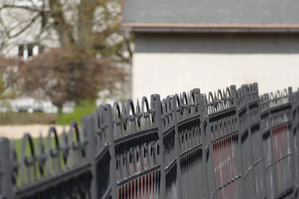 Black metal fence in a private garden — Stock Photo, Image