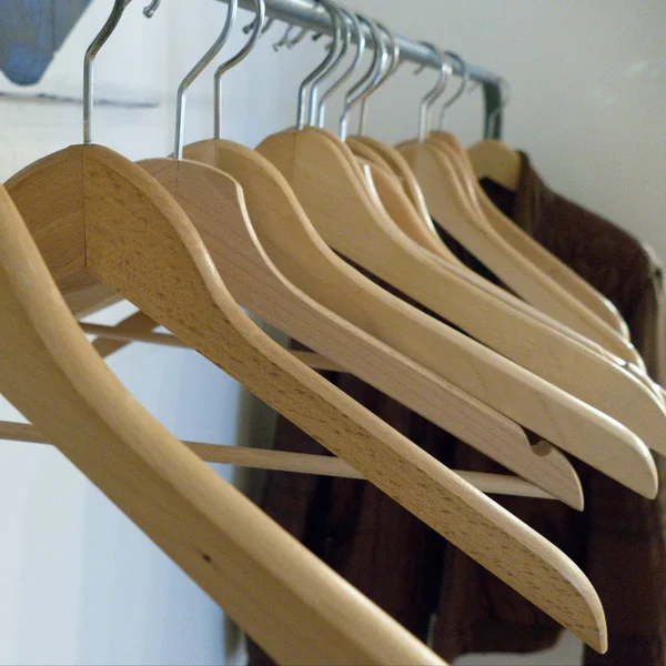 Detail of empty coat hangers on a line — Stock Photo, Image