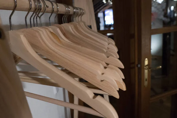 Rack full of empty wooden coathangers — Stock Photo, Image