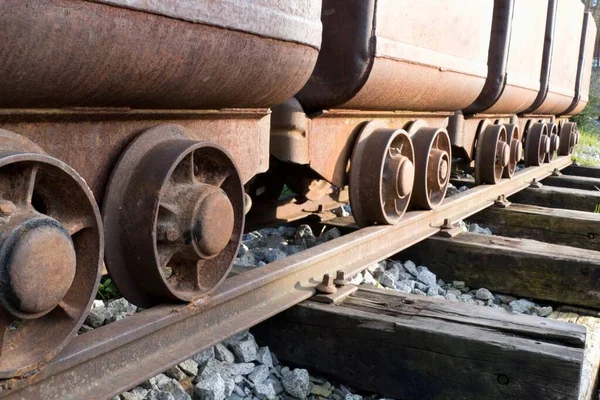 a row of empty old mine troleys on a rail