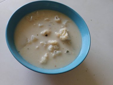 Bir kasede servis edilen beyaz karnabahar sütü çorbası.