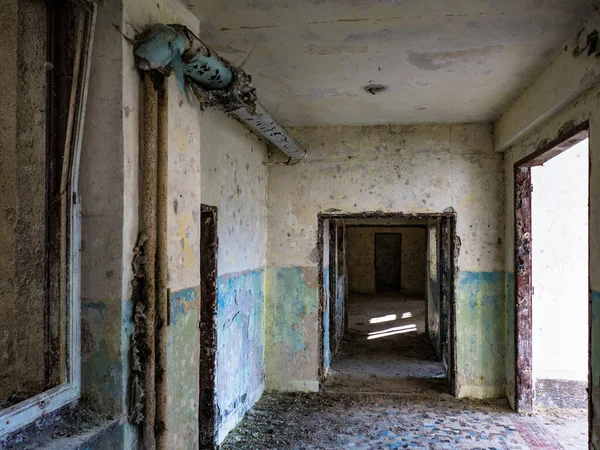 exploring the ruin of an abandoned country house with broken windows