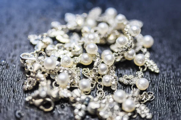 Pearl silver necklace Lying on a dark background