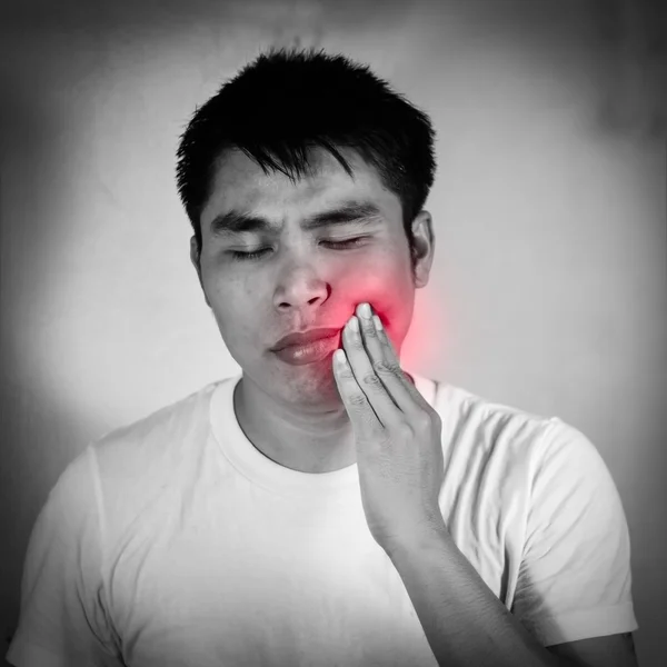 Asian man in a white t-shirt has a toothache — Stock Photo, Image