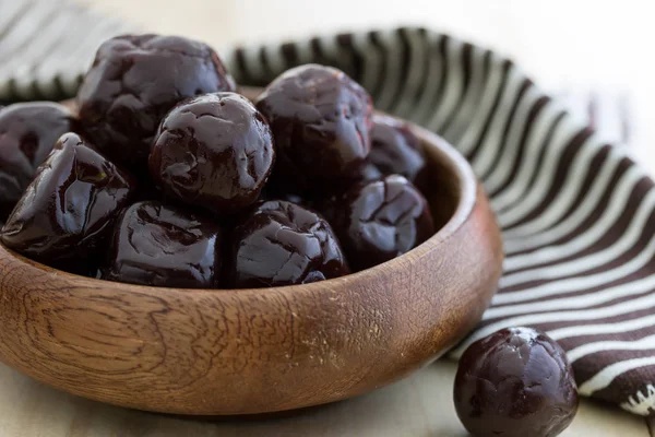 Dried plums on wood floor — Stock Photo, Image