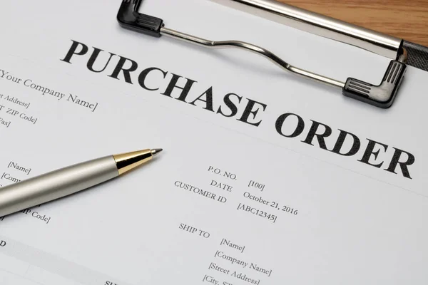 Close up of purchase order form with pen  / selective focus