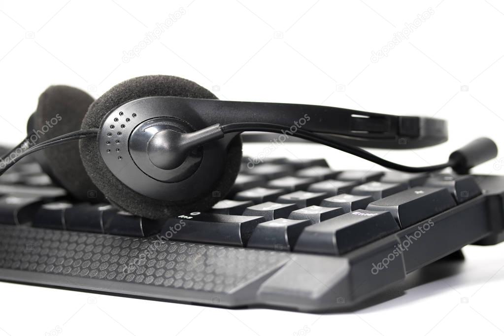 Headset with microphone on the keyboard. On white background