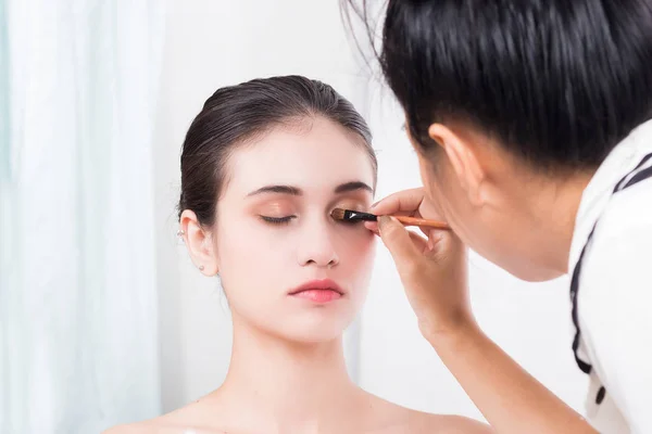 Models are makeup by makeup artist in photo studio. — Stock Photo, Image